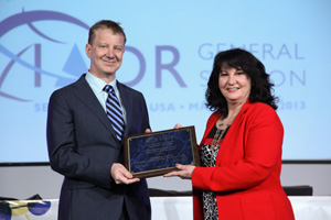 Dr. Christopher Overall receives the 2013 IADR Distinguished Scientist Award for Research in Oral Biology from then IADR president Mary MacDougall.