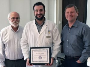 Dr. Georgios Giannelis (C), flanked by Dentistry dean Dr. Charles Shuler (L) and Dr. Hannu Larjava.